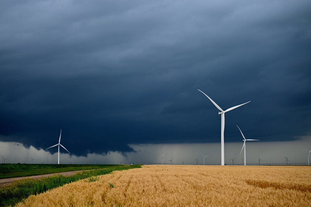 Thunderstorm amongst wind turbines in a field of crops