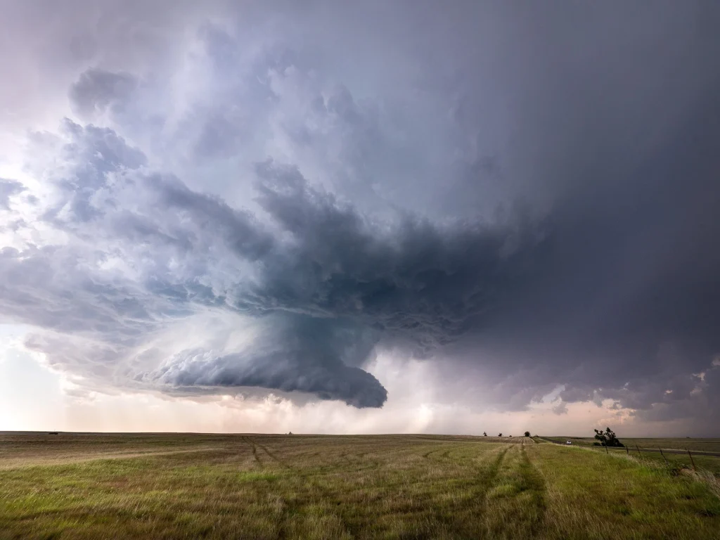 NOAA's Weather Program Office Homepage. Image of a storm brewing over large field.